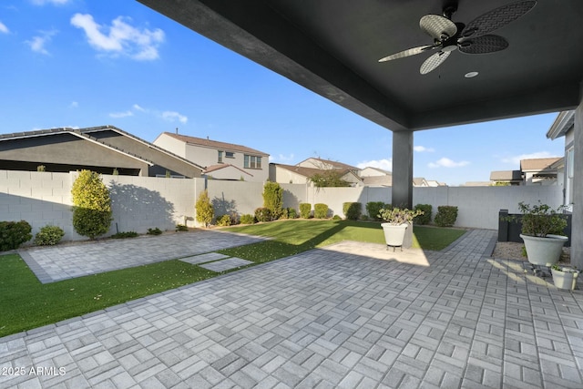 view of patio with a fenced backyard and ceiling fan
