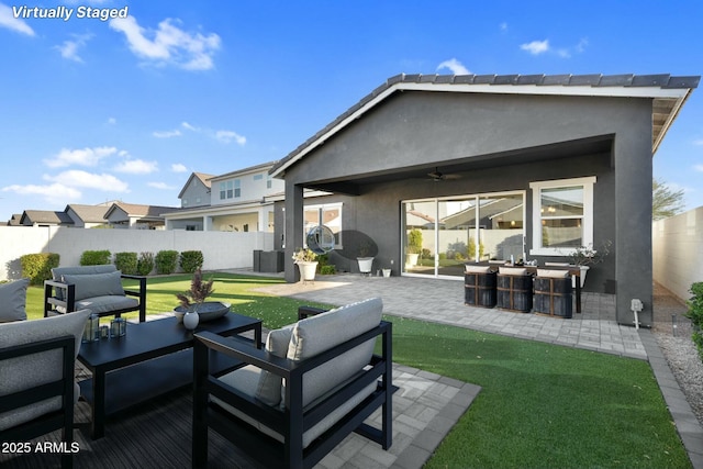 exterior space with a patio area, stucco siding, outdoor lounge area, and a fenced backyard