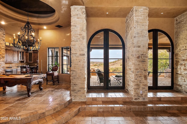 entryway with a towering ceiling and billiards