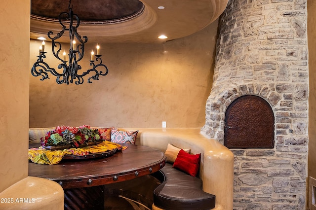 dining area with a tray ceiling, breakfast area, and a notable chandelier