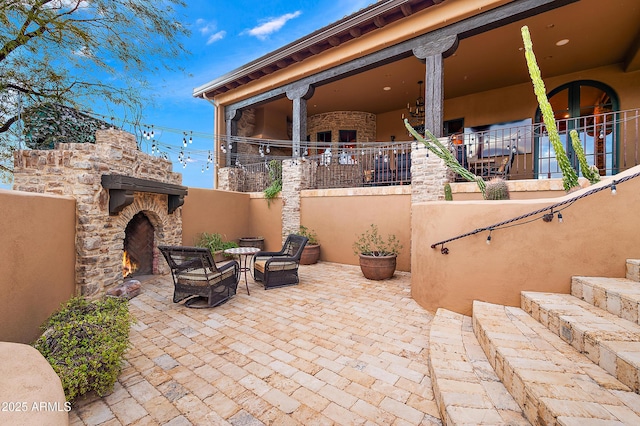 view of patio / terrace with an outdoor stone fireplace