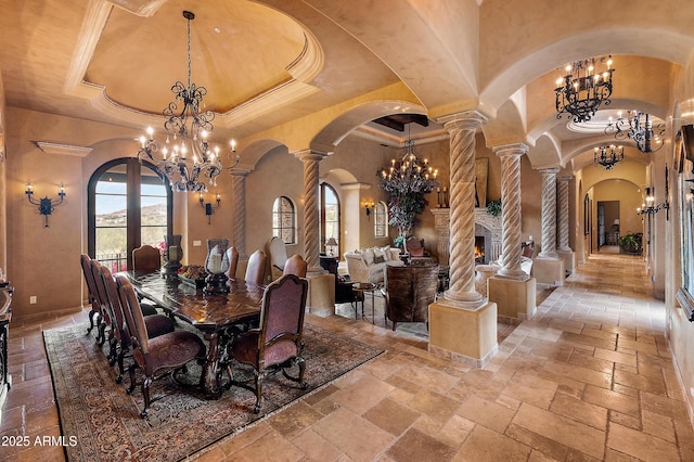 dining space with plenty of natural light, a towering ceiling, and a notable chandelier