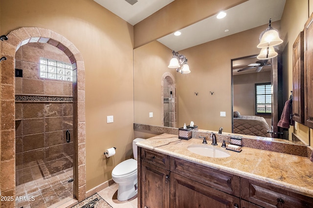 bathroom featuring vanity, toilet, and an enclosed shower