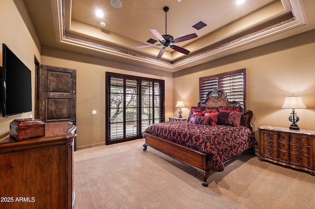 carpeted bedroom with ceiling fan, access to outside, and a tray ceiling