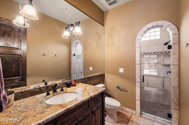 bathroom with toilet, vanity, tile patterned floors, and an enclosed shower