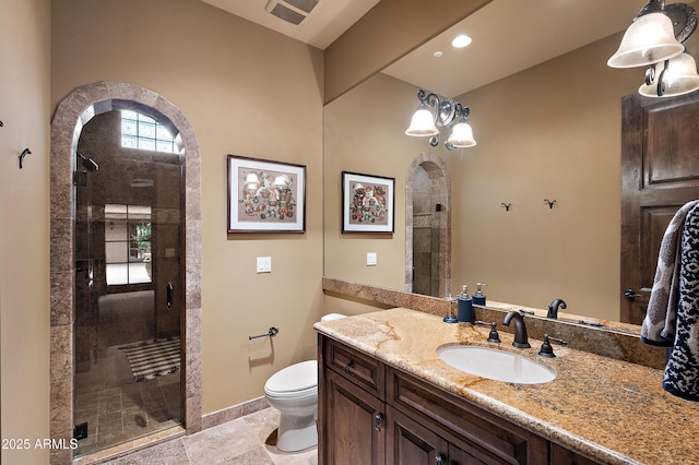 bathroom with vanity, toilet, and walk in shower