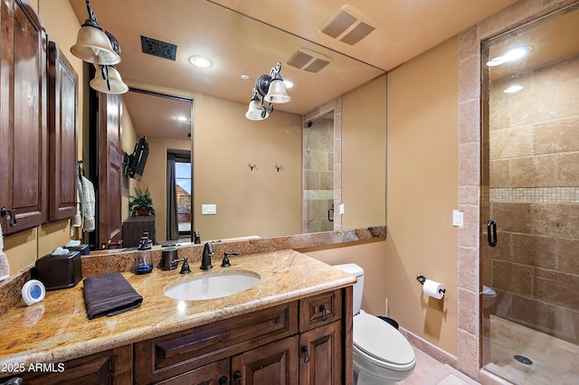 bathroom featuring a shower with door, vanity, and toilet