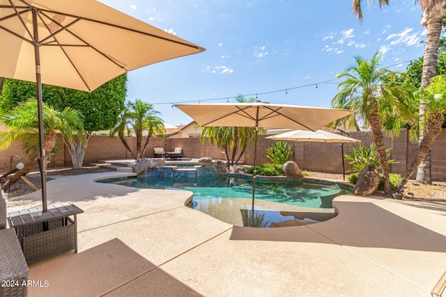 view of swimming pool featuring an in ground hot tub and a patio