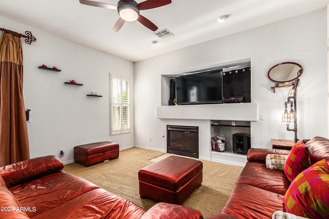 carpeted living room with ceiling fan