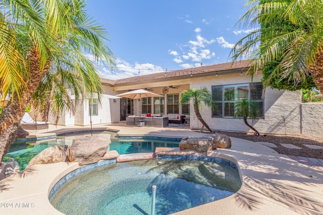 view of swimming pool featuring an in ground hot tub, ceiling fan, a patio, and an outdoor hangout area