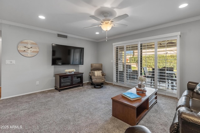 carpeted living room featuring ceiling fan and ornamental molding