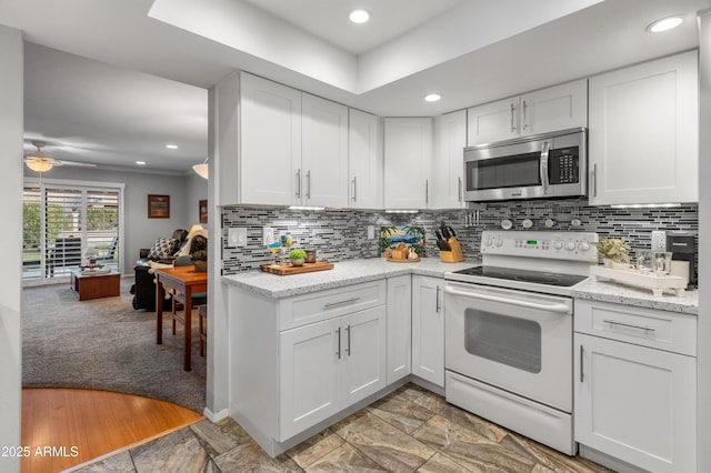 kitchen featuring white electric stove, white cabinetry, backsplash, ceiling fan, and light stone countertops