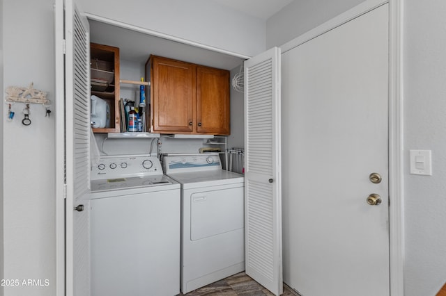 washroom featuring cabinets, hardwood / wood-style flooring, and washer and dryer