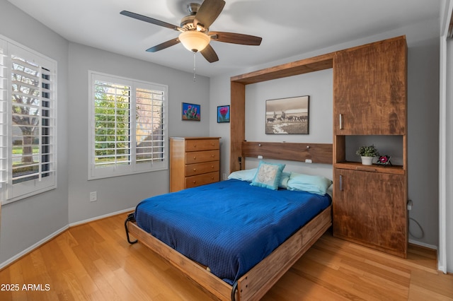 bedroom with light hardwood / wood-style flooring and ceiling fan