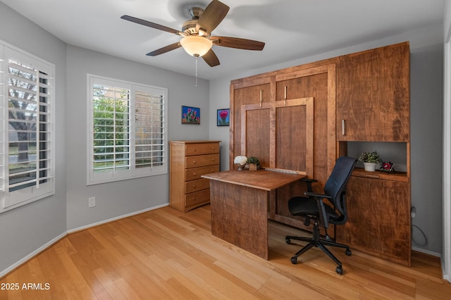 office with ceiling fan and light hardwood / wood-style flooring