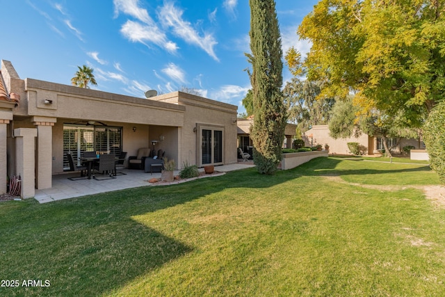 rear view of house featuring a patio area and a lawn