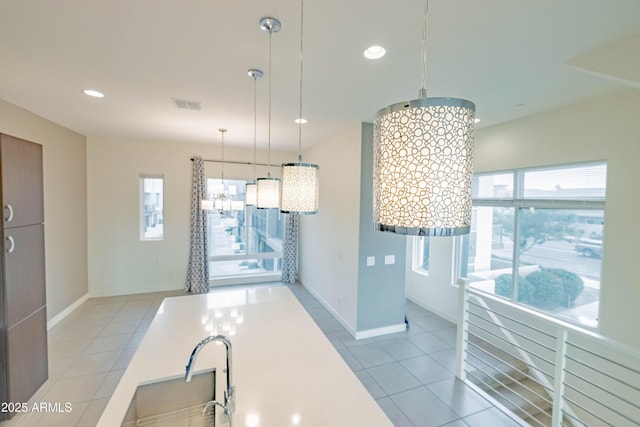 kitchen with hanging light fixtures and light tile patterned floors