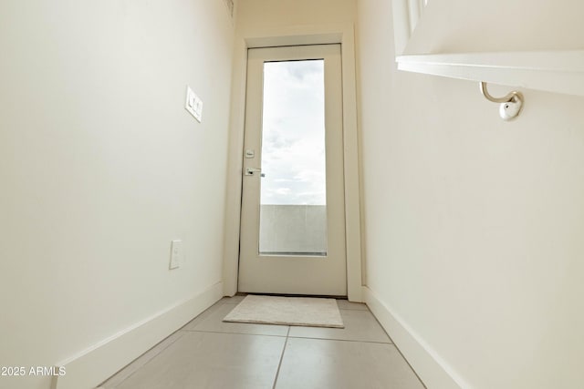 entryway featuring light tile patterned floors and plenty of natural light