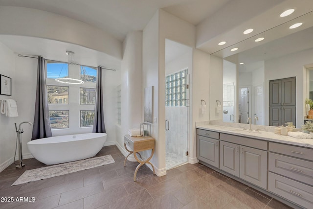 bathroom featuring plus walk in shower and vanity