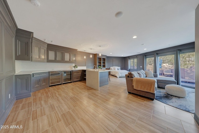 kitchen with sink, a center island, decorative light fixtures, and tasteful backsplash