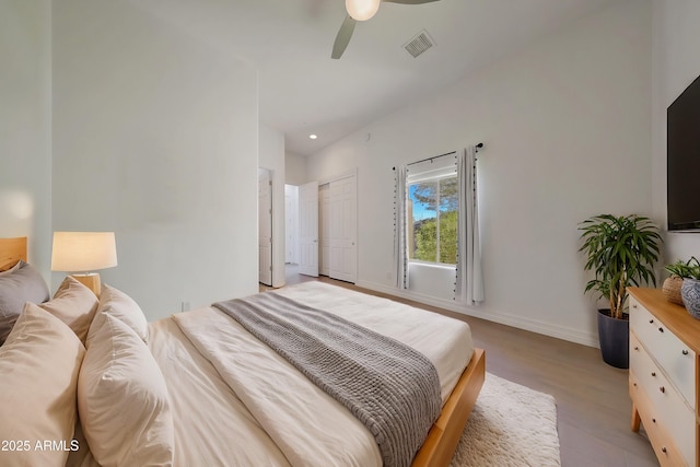 bedroom with ceiling fan, light hardwood / wood-style flooring, and a closet