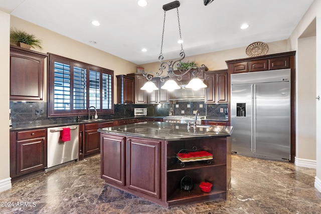 kitchen featuring a kitchen island with sink, dark tile patterned floors, backsplash, and stainless steel appliances