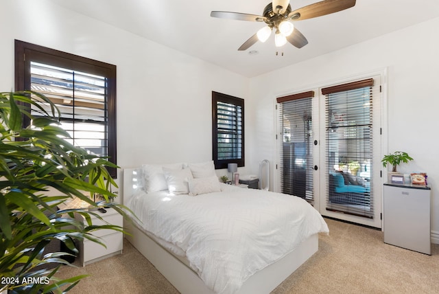 carpeted bedroom featuring french doors, access to outside, and ceiling fan