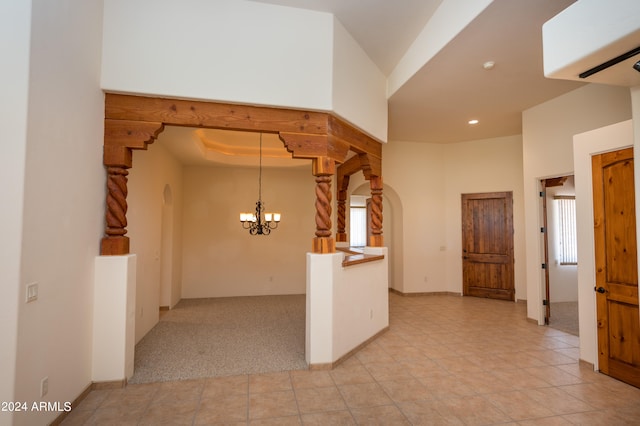 interior space featuring a notable chandelier and a towering ceiling