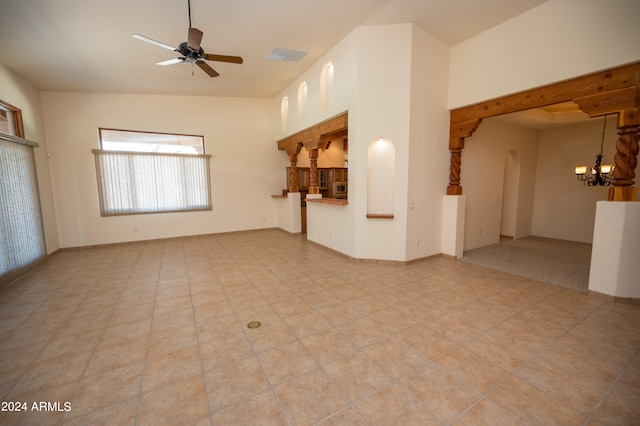 carpeted empty room with ceiling fan with notable chandelier
