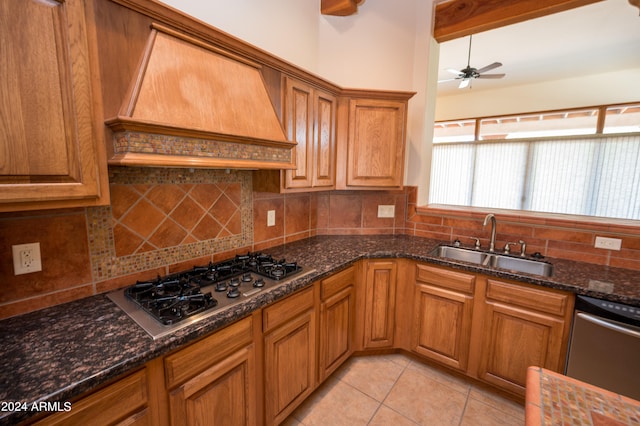 kitchen with ceiling fan, stainless steel appliances, premium range hood, backsplash, and sink