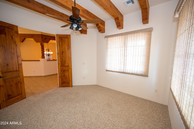 tiled empty room with ceiling fan with notable chandelier and beam ceiling