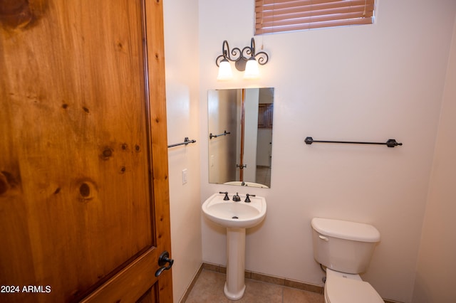 bathroom featuring tile floors and toilet