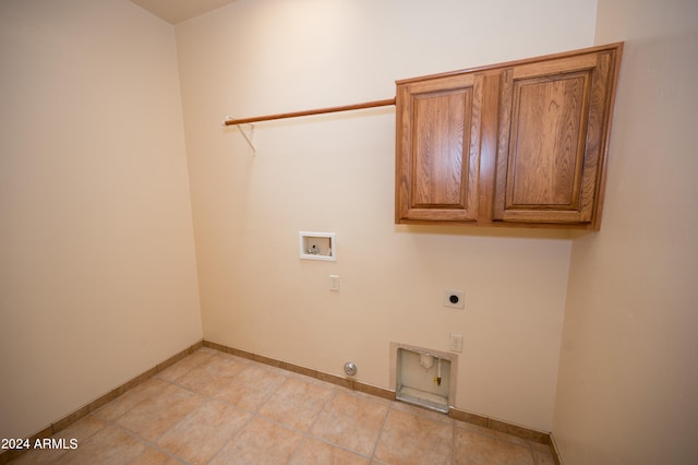 washroom featuring hookup for a gas dryer, electric dryer hookup, tile floors, and hookup for a washing machine