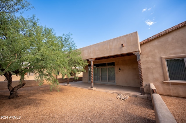 rear view of property featuring a patio area