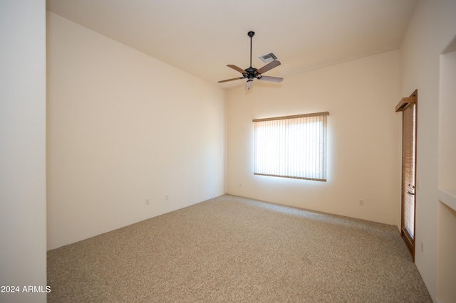 carpeted spare room with ceiling fan