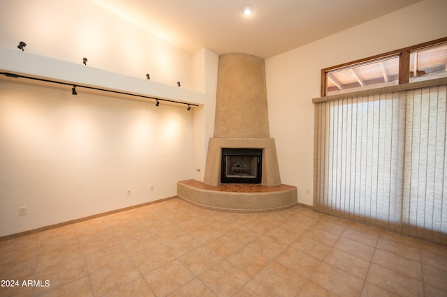 unfurnished living room featuring tile floors and a fireplace