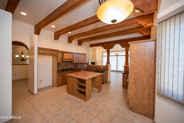 kitchen featuring a center island, stainless steel dishwasher, premium range hood, tasteful backsplash, and light tile flooring