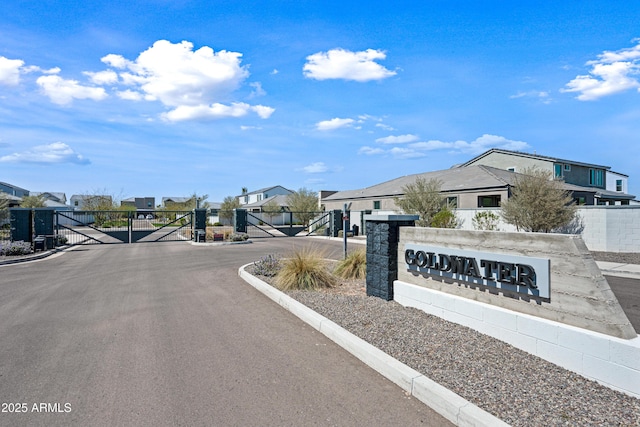 2326 E Levi Dr, Phoenix, AZ 85040 - view of asphalt road with a gate, a residential view, a gated entry, and curbs