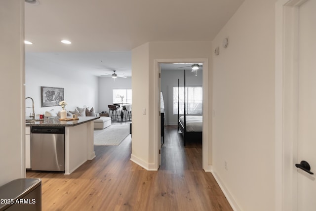 hallway featuring light hardwood / wood-style floors and sink