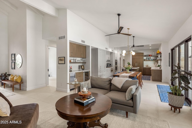 5438 E Lupine Ave, Scottsdale, AZ 85254 - living area featuring a ceiling fan, high vaulted ceiling, beverage cooler, light tile patterned floors, and baseboards