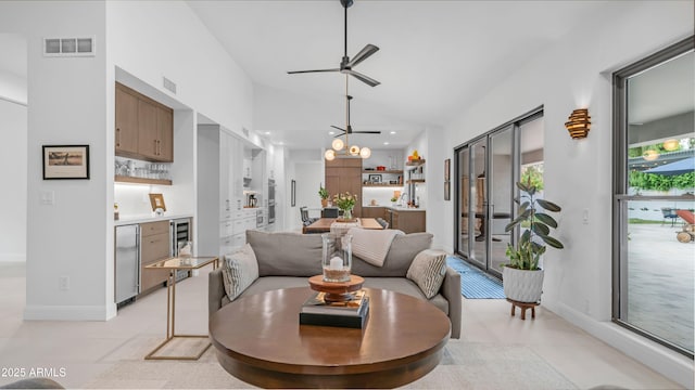 5438 E Lupine Ave, Scottsdale, AZ 85254 - living area featuring vaulted ceiling, ceiling fan, baseboards, recessed lighting, and wine cooler