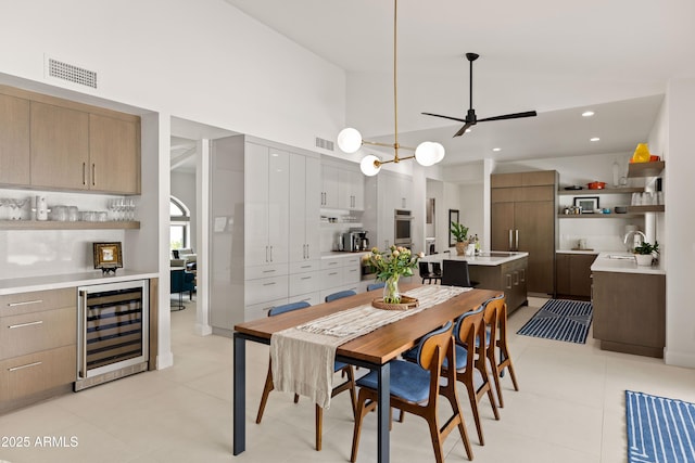 5438 E Lupine Ave, Scottsdale, AZ 85254 - dining room featuring wine cooler, a ceiling fan, a towering ceiling, and light tile patterned floors