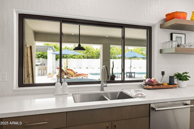 5438 E Lupine Ave, Scottsdale, AZ 85254 - kitchen featuring a sink, stainless steel dishwasher, light countertops, and pendant lighting