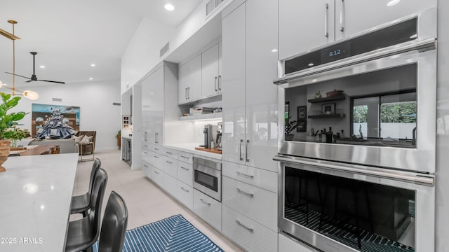 5438 E Lupine Ave, Scottsdale, AZ 85254 - kitchen with double oven, white cabinets, decorative light fixtures, modern cabinets, and recessed lighting