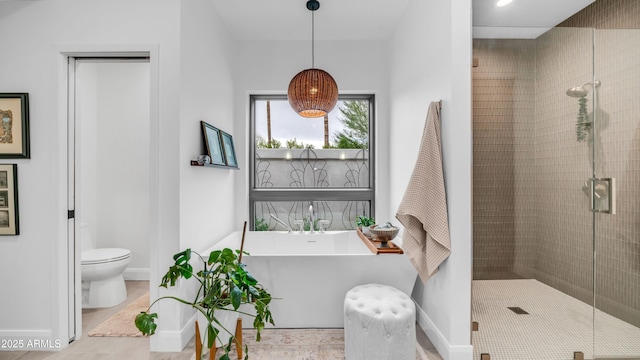 5438 E Lupine Ave, Scottsdale, AZ 85254 - bathroom featuring a soaking tub, baseboards, a stall shower, and toilet