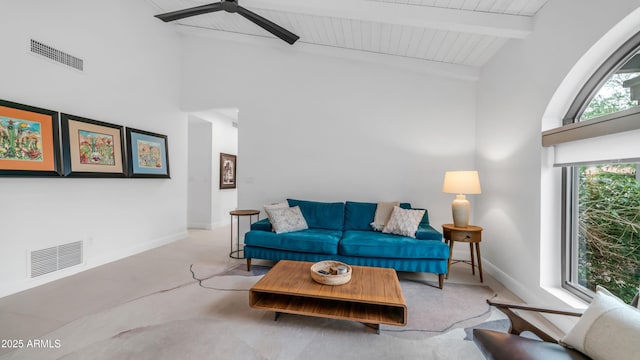 5438 E Lupine Ave, Scottsdale, AZ 85254 - carpeted living room with high vaulted ceiling, ceiling fan, baseboards, and wooden ceiling with exposed beams