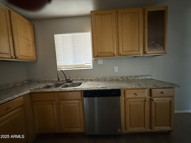 kitchen featuring light countertops, dishwasher, a sink, and light brown cabinetry