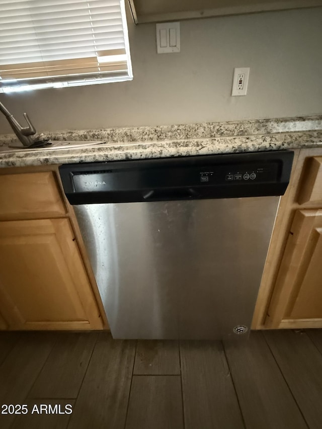 room details featuring dishwasher, a sink, and wood finished floors