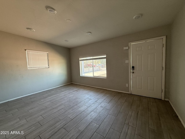 interior space featuring baseboards and wood finished floors