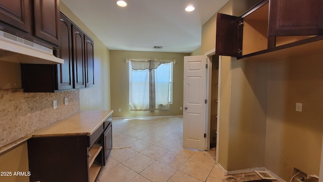4432 W Pleasant Ln, Laveen, AZ 85339 - kitchen with light countertops, light tile patterned flooring, dark brown cabinets, recessed lighting, and baseboards